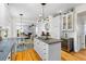 A modern kitchen with a central island flows seamlessly into a comfortable living area with a fireplace at 1164 Out Of Bounds Dr, Summerville, SC 29485