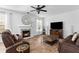 Cozy living room featuring a fireplace with stone surround and comfortable brown reclining sofas at 1164 Out Of Bounds Dr, Summerville, SC 29485