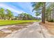 View of paved path with the golf course and neighborhood in the background at 1164 Out Of Bounds Dr, Summerville, SC 29485