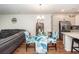 Bright dining area features hardwood floors, glass table, leaf-patterned chairs and stainless-steel appliances in the kitchen at 118 Alpine Rd, Summerville, SC 29485