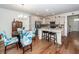 Bright kitchen features hardwood floors, dining table, stainless-steel appliances, backsplash and an island with barstool seating at 118 Alpine Rd, Summerville, SC 29485