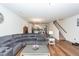 Open concept floor plan with living room leading into the kitchen. Hardwood flooring and a large sectional sofa at 118 Alpine Rd, Summerville, SC 29485
