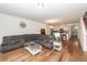 Open concept floor plan with living room leading into the kitchen. Hardwood flooring and a large sectional sofa at 118 Alpine Rd, Summerville, SC 29485