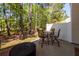 Cozy patio featuring an outdoor seating area, privacy fence, and wooded views beyond at 118 Alpine Rd, Summerville, SC 29485