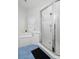 Well-lit bathroom with a glass shower, soaking tub under a window, and blue tile flooring at 122 Lucia St, Charleston, SC 29492