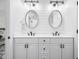 Bright bathroom featuring double vanity, shiplap walls, and modern lighting and hardware at 122 Lucia St, Charleston, SC 29492