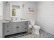 Stylish half-bath with elegant vanity, framed mirror and attractive decorative floors at 122 Lucia St, Charleston, SC 29492