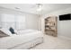 Bright bedroom with white walls, a ceiling fan, a TV, and a decorative bookshelf at 122 Lucia St, Charleston, SC 29492