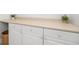 Neutral cabinets with silver knobs, light countertops, and foliage decorations on top at 122 Lucia St, Charleston, SC 29492