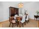 Bright dining room with a wood table, upholstered chairs, a chandelier, and natural light streaming in at 122 Lucia St, Charleston, SC 29492