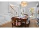 Charming dining room with a classic wood table, shuttered windows, and an elegant chandelier for a cozy ambiance at 122 Lucia St, Charleston, SC 29492