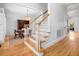 Elegant foyer featuring hardwood floors, a staircase with white railings, and an open view to the dining room at 122 Lucia St, Charleston, SC 29492