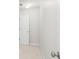 Bright hallway with neutral carpet, white baseboards, and doors leading to other rooms at 122 Lucia St, Charleston, SC 29492