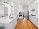 Spacious white kitchen featuring an island, stainless steel appliances, and hardwood flooring throughout the space at 122 Lucia St, Charleston, SC 29492