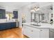 Open-concept kitchen with white island and dark navy wet bar, perfect for entertaining and everyday living at 122 Lucia St, Charleston, SC 29492