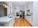 Modern kitchen with white cabinets, stainless steel appliances, hardwood floors, and a quartz countertop island at 122 Lucia St, Charleston, SC 29492