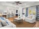 Open-concept living space with a glimpse of the kitchen, hardwood floors, and comfortable seating, ideal for relaxation at 122 Lucia St, Charleston, SC 29492