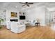 Bright and airy living room with fireplace, built-in shelving, hardwood floors and comfortable seating arrangement at 122 Lucia St, Charleston, SC 29492