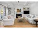 Cozy living room with a fireplace, built-in shelving, and comfortable white furniture, creating an inviting space at 122 Lucia St, Charleston, SC 29492