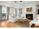 Bright living room with a fireplace, built-in shelves, hardwood floors, and comfortable seating for gatherings at 122 Lucia St, Charleston, SC 29492