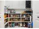 Organized pantry with ample shelving, white cabinets, and a variety of neatly arranged food items and kitchenware at 122 Lucia St, Charleston, SC 29492