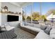 Relaxing screened porch with comfortable seating, a TV, and outdoor views at 122 Lucia St, Charleston, SC 29492