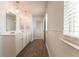 Bathroom featuring a dual sink vanity, wood-look flooring, and a window at 131 Cloverleaf St, Summerville, SC 29483