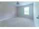 This bedroom features plush carpeting, a ceiling fan, and natural light from the window at 131 Cloverleaf St, Summerville, SC 29483