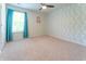 Inviting bedroom with leafy wallpaper, ceiling fan, neutral carpet, and window at 131 Cloverleaf St, Summerville, SC 29483