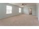 Spacious bedroom featuring neutral walls, carpet, a ceiling fan, and windows with neighborhood views at 131 Cloverleaf St, Summerville, SC 29483