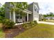 Inviting two-story home featuring a charming front porch and well-maintained landscaping at 131 Cloverleaf St, Summerville, SC 29483