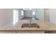 Granite countertops, double sink, and open access to the living area make this kitchen desirable at 131 Cloverleaf St, Summerville, SC 29483