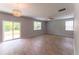 Airy living room boasts natural light, wood-look floors, modern lighting, and slider access to outdoors at 131 Cloverleaf St, Summerville, SC 29483