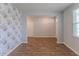 Open room featuring hardwood floors, light grey walls, and a doorway at 131 Cloverleaf St, Summerville, SC 29483