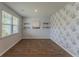 Bright room with hardwood floors, decorative wallpaper, and natural light from the window at 131 Cloverleaf St, Summerville, SC 29483