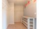 Walk-in closet with shelving and a table for storage, complemented by a floral accent wall at 131 Cloverleaf St, Summerville, SC 29483