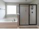 Bright bathroom featuring a separate shower and soaking tub, perfect for relaxation at 138 Shadybrook Dr, Summerville, SC 29486
