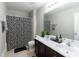 Bathroom featuring double sink vanity, black and white shower curtain, and neutral tile flooring at 138 Shadybrook Dr, Summerville, SC 29486