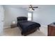 Cozy bedroom featuring a queen bed with black bedding, a ceiling fan, and a window for natural light at 138 Shadybrook Dr, Summerville, SC 29486
