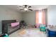 Bright Bedroom featuring a crib, ceiling fan, decorative wall art, and a window with bright, natural light at 138 Shadybrook Dr, Summerville, SC 29486