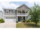 Charming two-story home with a welcoming front porch and a well-maintained lawn at 138 Shadybrook Dr, Summerville, SC 29486