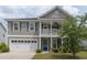 Charming two-story home boasts a welcoming porch and a convenient attached two-car garage at 138 Shadybrook Dr, Summerville, SC 29486