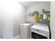 Well-lit laundry room equipped with a washer, dryer, and shelving for storage at 138 Shadybrook Dr, Summerville, SC 29486