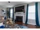 Bright living room featuring a fireplace, large windows, and modern accents at 138 Shadybrook Dr, Summerville, SC 29486