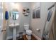 Stylish powder room with a pedestal sink, decorative mirror, and modern fixtures at 138 Shadybrook Dr, Summerville, SC 29486