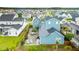 Aerial view of a blue home with a fenced-in backyard, patio with outdoor seating, and manicured lawn at 141 Sandy Bend Ln, Summerville, SC 29486