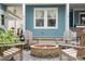 Inviting backyard fire pit surrounded by Adirondack chairs and a brick patio at 141 Sandy Bend Ln, Summerville, SC 29486