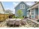 Backyard with dining table, chairs, lush greenery, and landscaped yard at 141 Sandy Bend Ln, Summerville, SC 29486