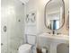Well-lit bathroom with a glass enclosed shower, pedestal sink, and mirrored medicine cabinet at 141 Sandy Bend Ln, Summerville, SC 29486