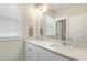 Bright bathroom featuring a double vanity with quartz countertop, mirrors, and natural light from the window at 141 Sandy Bend Ln, Summerville, SC 29486